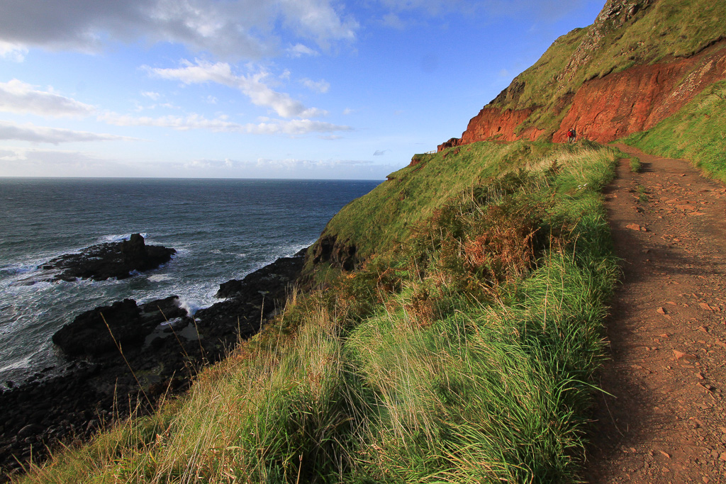 Red Laterite cliffs coming into view - Giant's Causeway