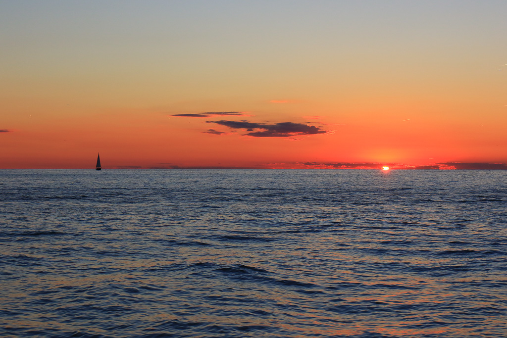 Setting sun and sailboat - Headlands Dunes